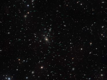 A vast star field with countless stars and distant galaxies in deep space.