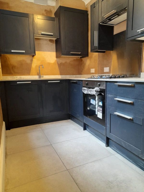 new kitchen installation in darker wood at a refurb project in Liverpool 