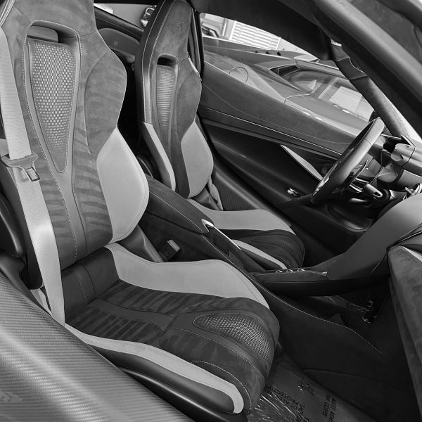 Luxurious sports car interior with bucket seats.