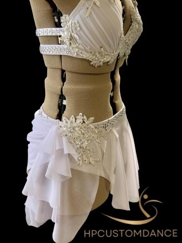 Elegant white dance costume on a mannequin.