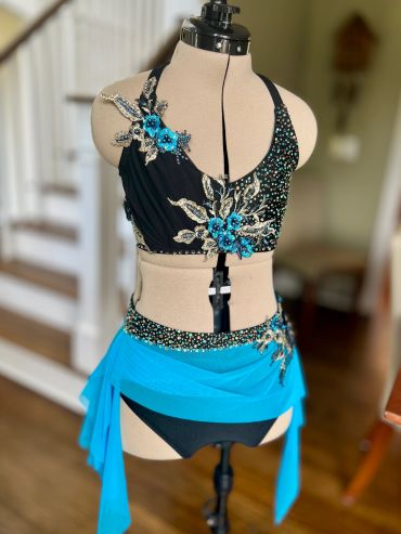 Black and blue embellished dance costume on mannequin.