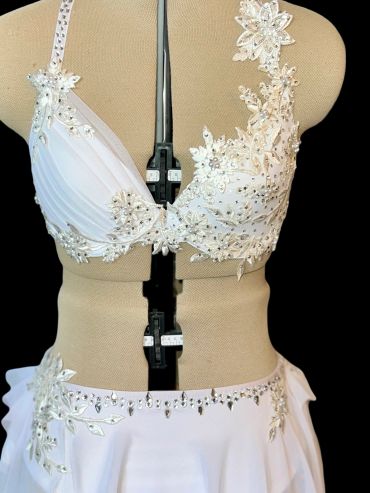 White embellished two-piece dress on mannequin.
