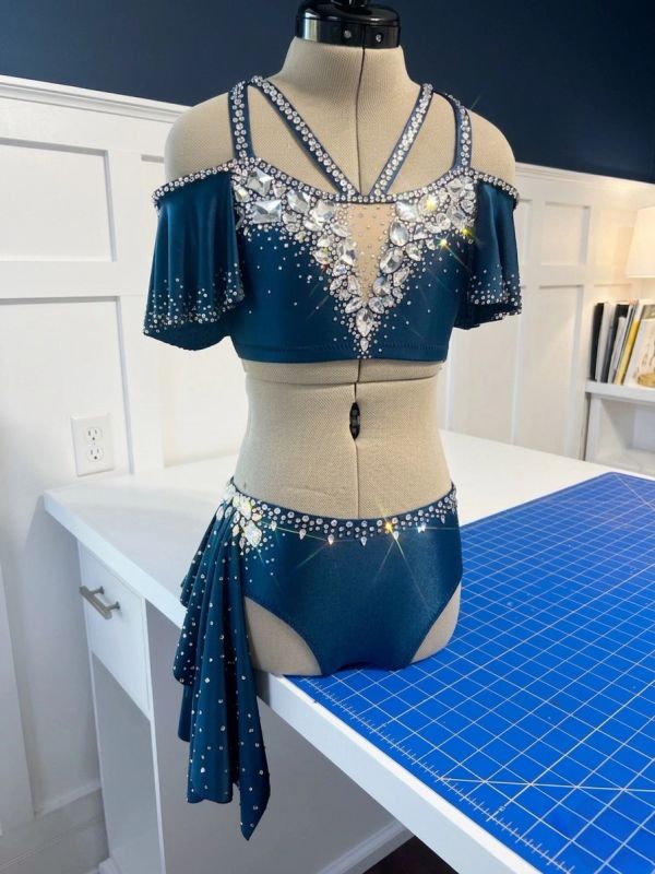 Sparkling blue dance costume with rhinestones on mannequin.
