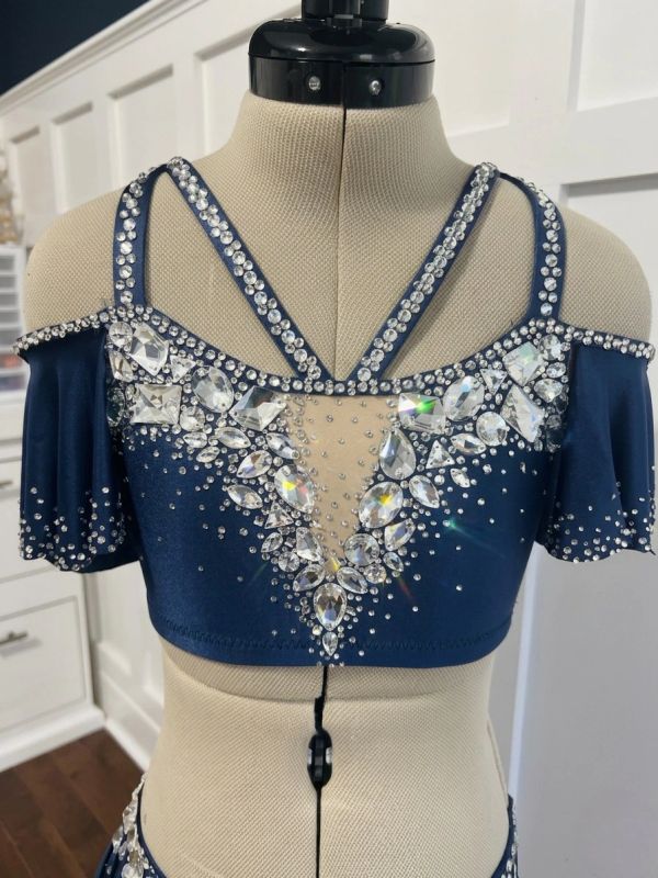Navy blue rhinestone embellished crop top on mannequin.