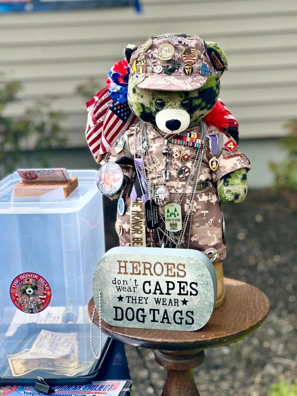 Military teddy bear with patriotic decor and dog tags saying heroes wear dog tags.