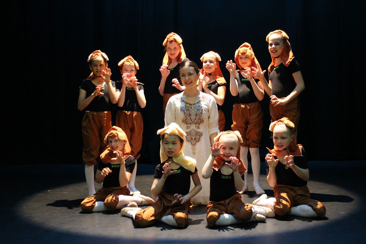 Ballet dancers in animal costumes with their instructor.