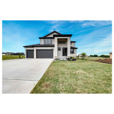 Modern two-story house with a large driveway and garage.