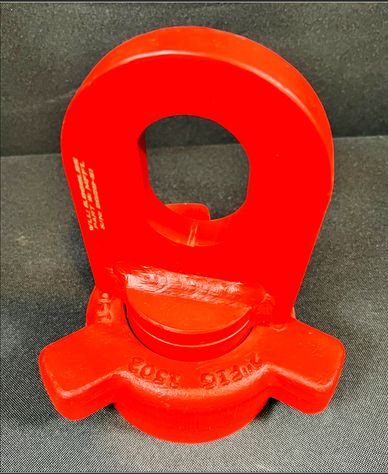 Bright red industrial lifting hook with safety latch on black background.