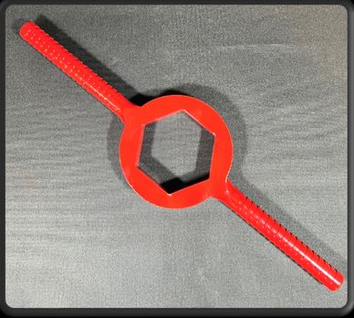 Red plastic tool with a hexagonal center and two handles.