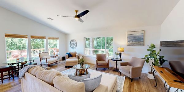 Bright and cozy living room with modern furniture and large windows.