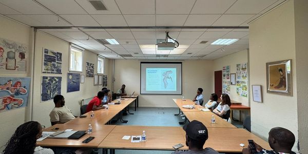 A group attending a medical presentation on heart anatomy in a classroom.