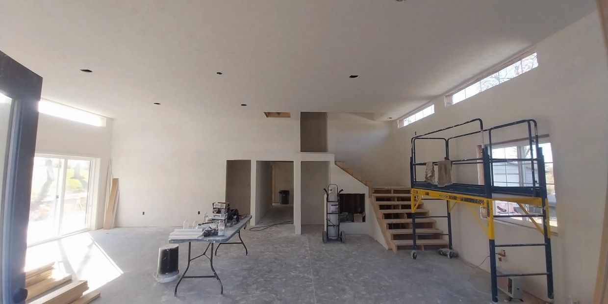 Room under construction with scaffolding and tools.