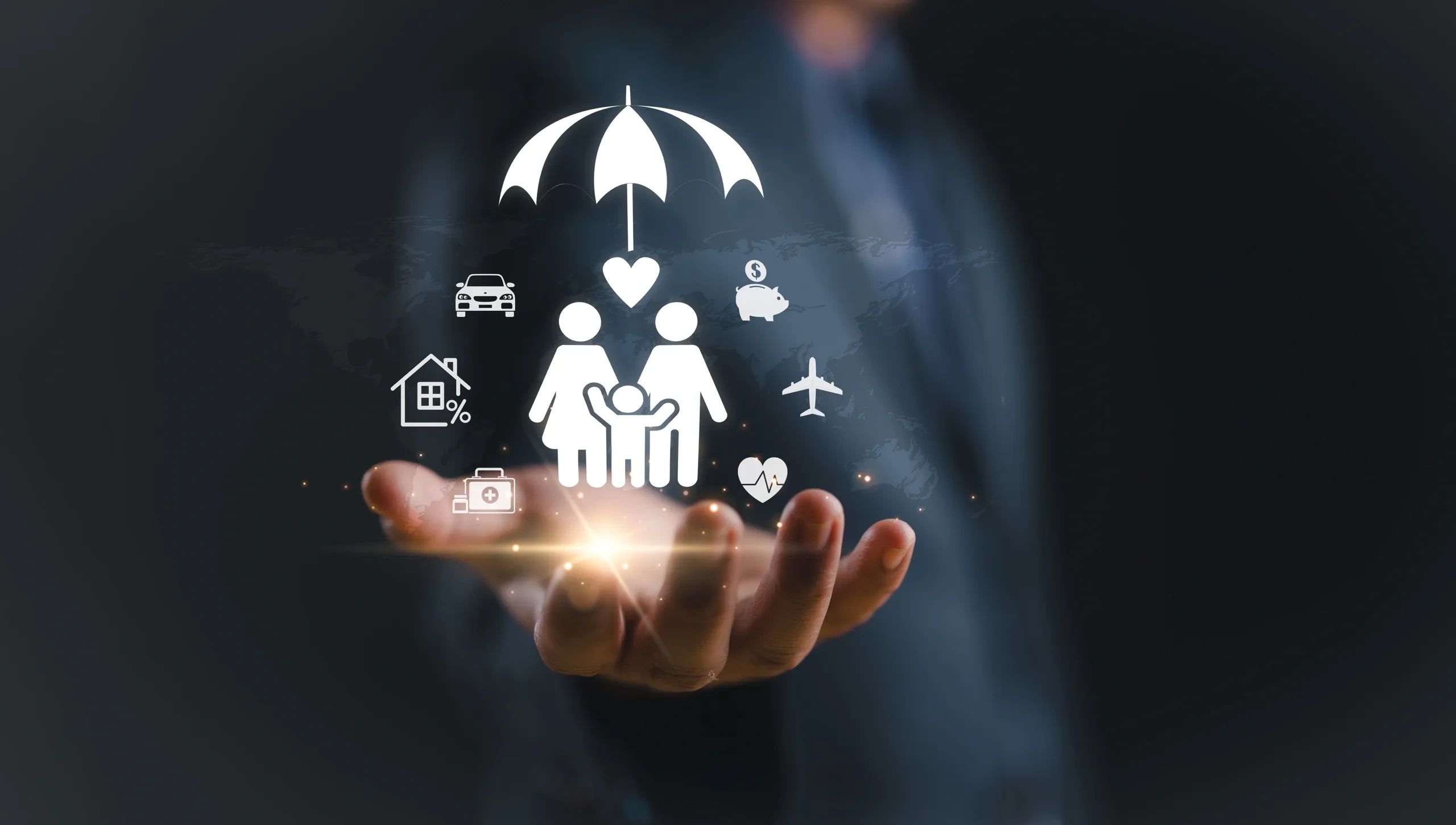 Icons representing family protection under an umbrella above a hand.