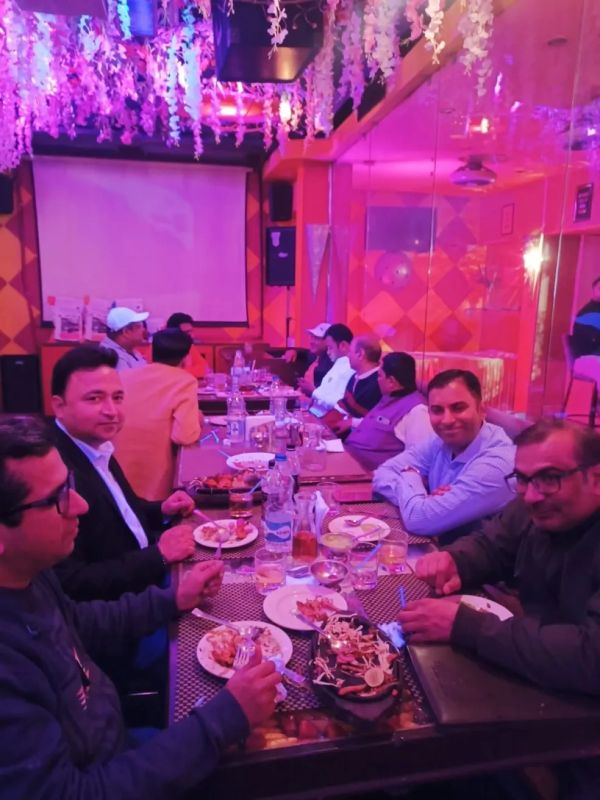 Group of men dining together in a colorful restaurant.