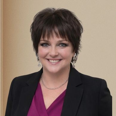 Smiling woman with short dark hair in professional attire.