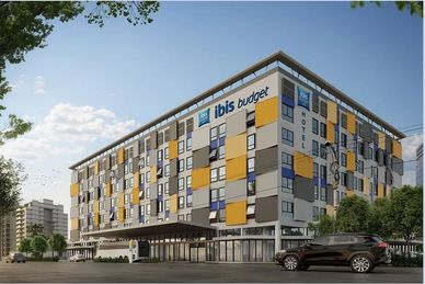 Modern ibis budget hotel building with colorful exterior panels.
