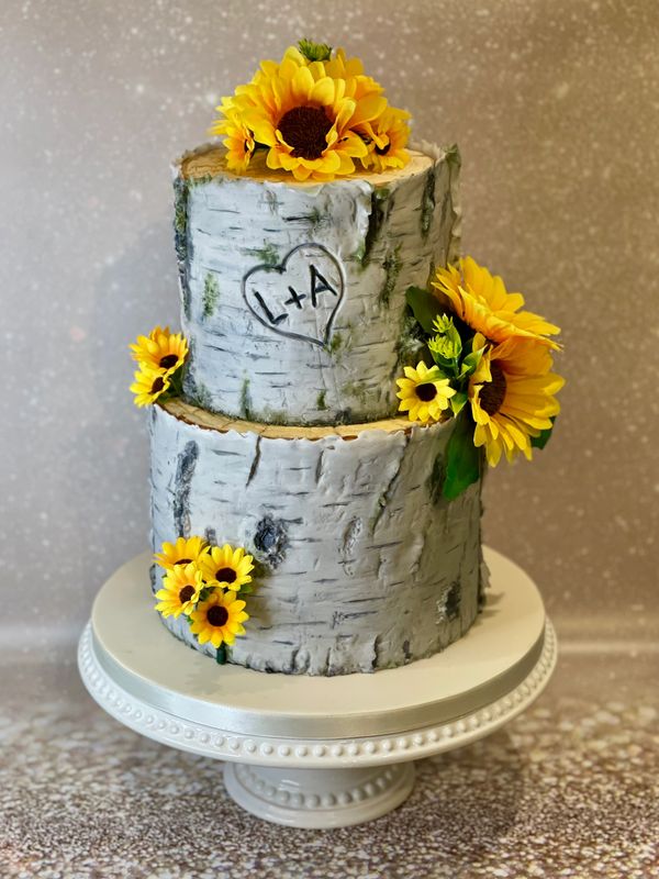 2 tier Silver Birch Tree Stump wedding cake with artificial sunflowers