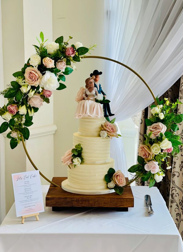 Rustic textured ivory buttercream 3 tier wedding cake with artifical blush and white roses
