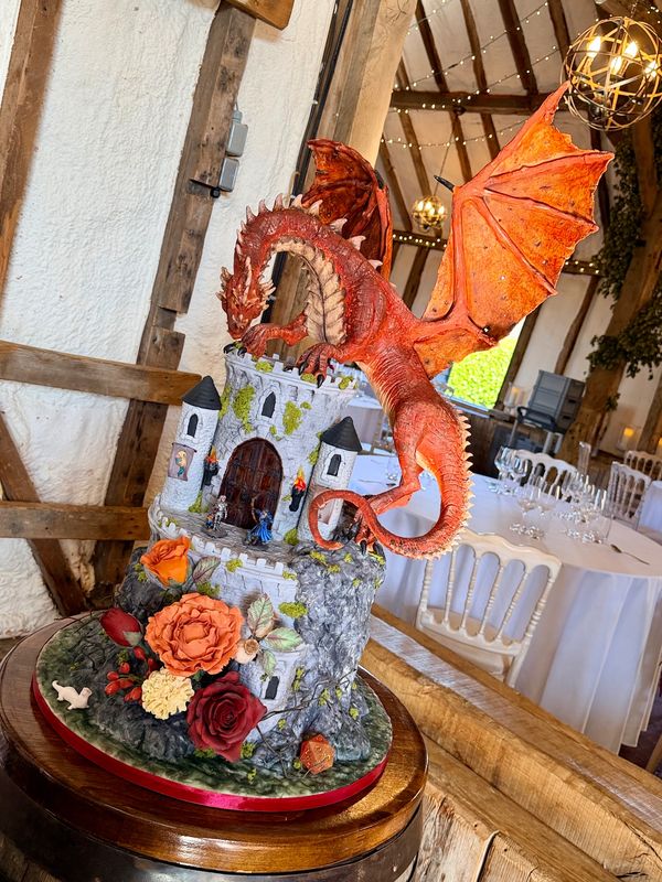 Dungeons & Dragons Wedding cake with large handmade dragon, castle and flowers