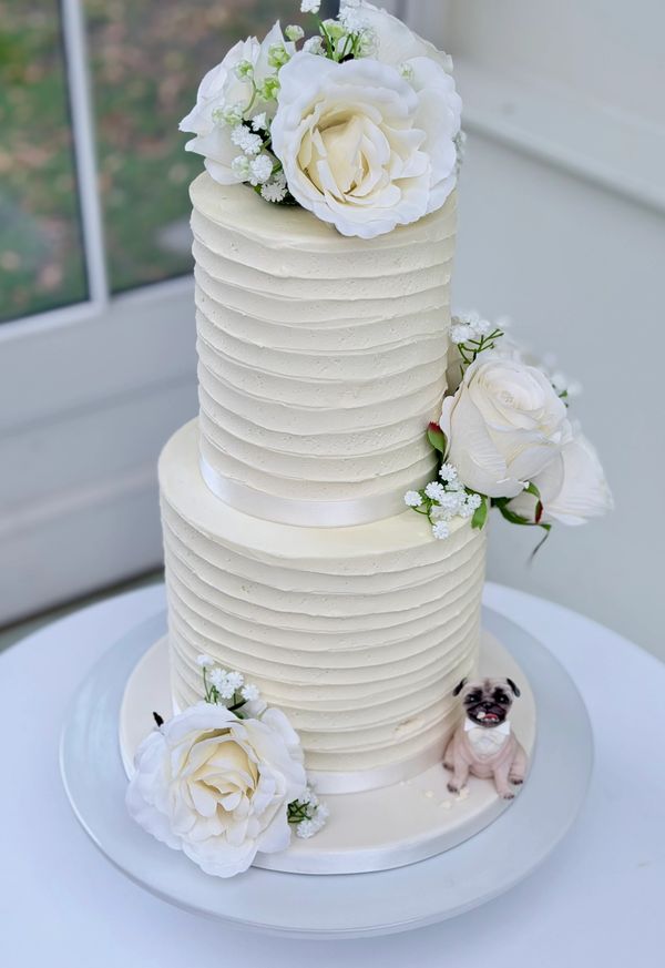 soft Textured Ivory buttercream cake with ivory roses and handmade pug dog