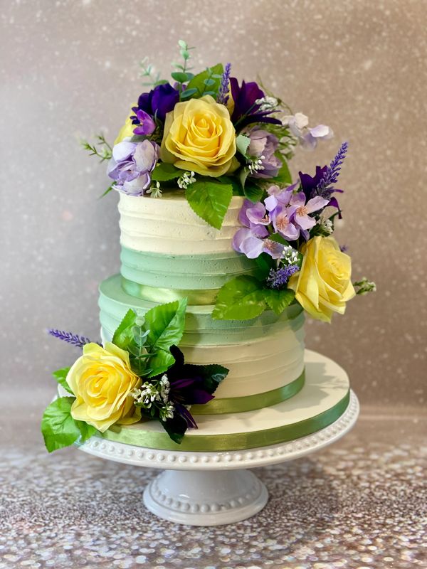 Small textured buttercream wedding cake in sage green and ivory with artificial flowers