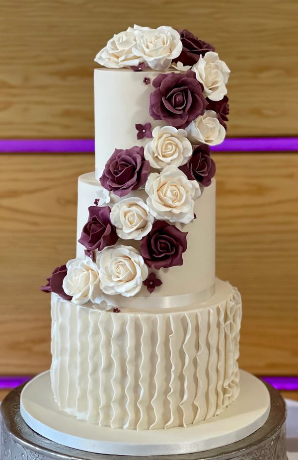 3 tier ivory and burgundy wedding cake with cascading sugar roses