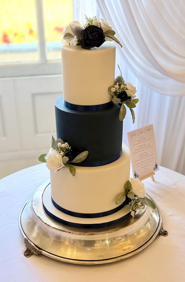 Elegant 3 tier navy and white fondant wedding cake