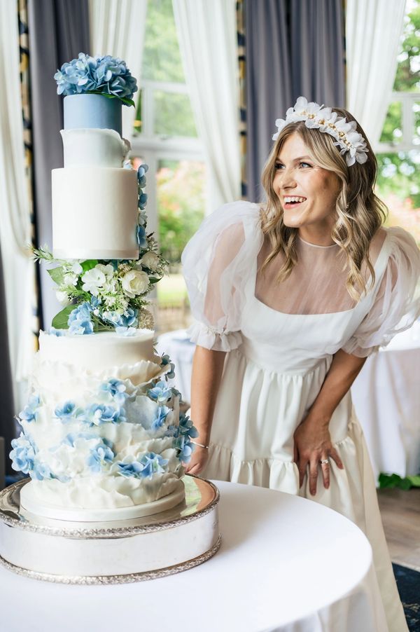 4 tier ivory and hydrangea blue ruffle wedding cake with silk hydrangeas, floating tier wedding cake