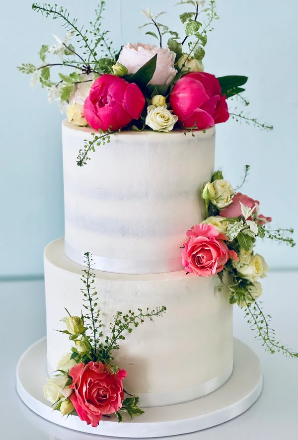 Simple semi naked style 2 tier wedding cake with pretty fresh flowers