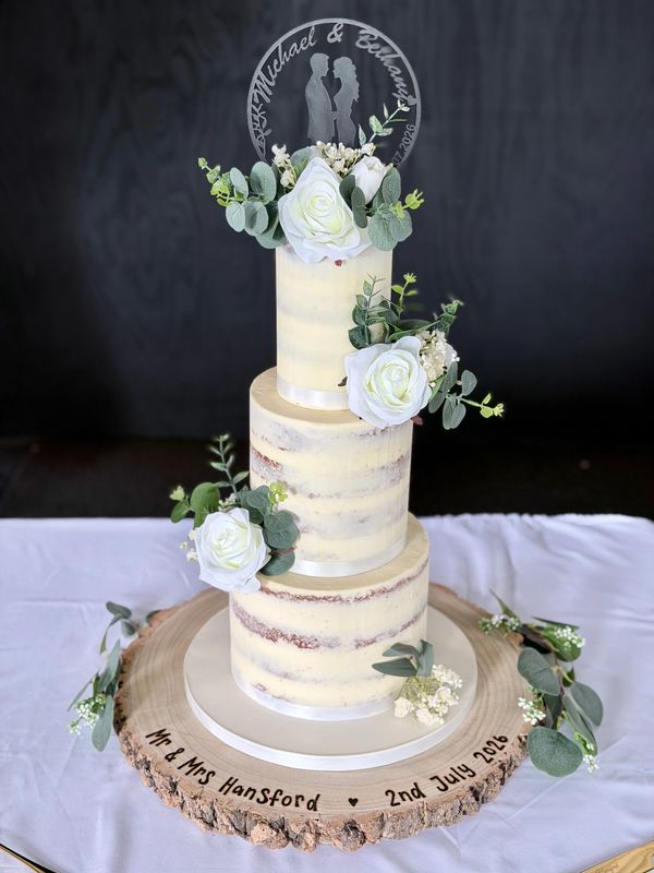 Semi naked 3 tier wedding cake with white silk flowers 
