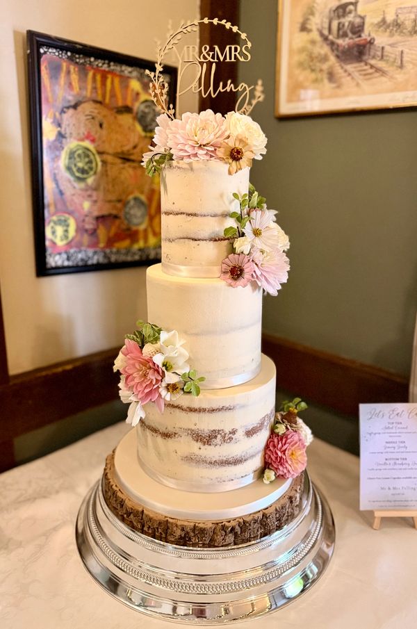 3 tier semi naked rustic wedding cake with pretty fresh flowers
