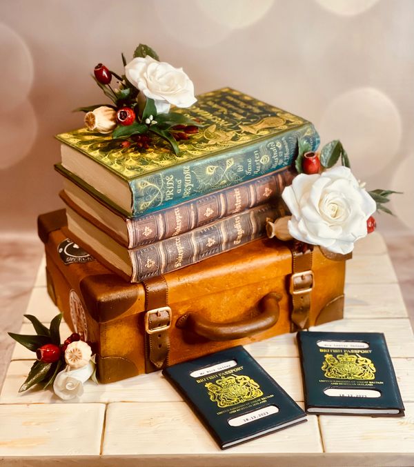 Suitcase wedding cake with stack of books cake, handmade sugar flowers, edible passports