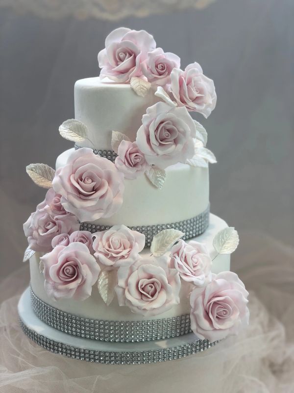 3 tiered wedding cake with cascade of pink fondant roses