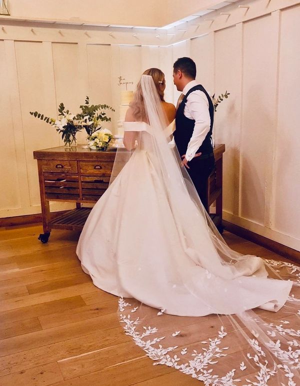 Bride and groom with their wedding cake