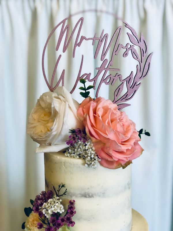 Semi naked wedding cake with personalised cake topper