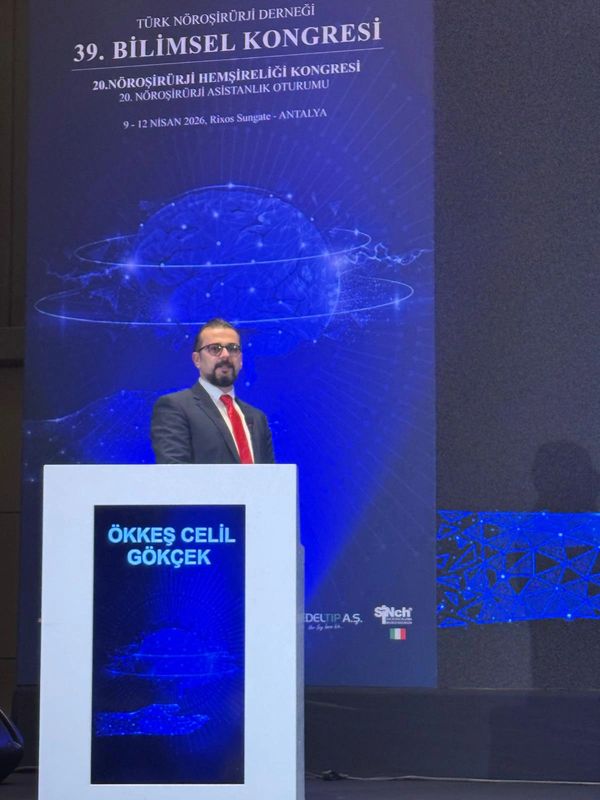 A man standing at a podium during the 39th Scientific Congress of Turkish Neurosurgery Association.