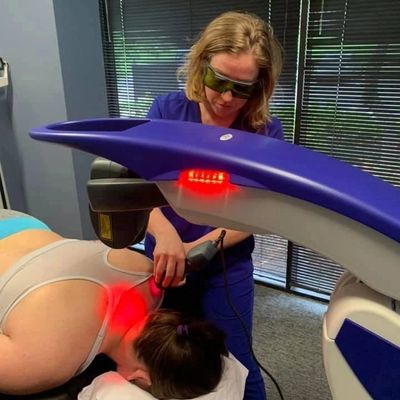 Dr. Andrea Ellis is using the MLS Laser to decrease pain  in the neck to relieve a migraine.