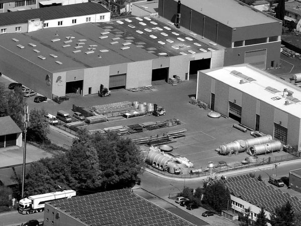 Aerial view of an industrial complex with warehouses and outdoor storage.