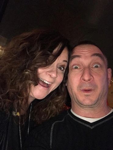 A man and woman making funny faces in a selfie.