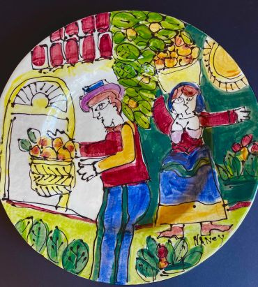 Colorful folk art plate with a man and woman amidst fruit and plants.