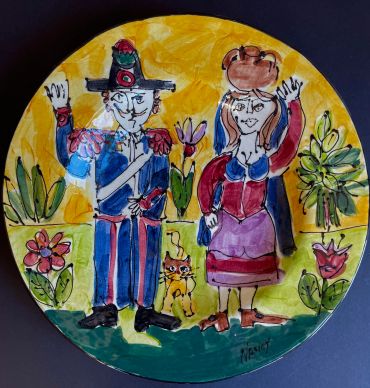 Colorful artistic plate showing a man, woman, and cat with flowers.