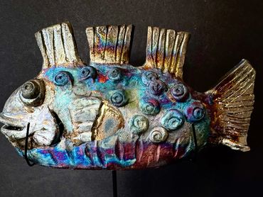 Colorful artistic fish sculpture with intricate designs.