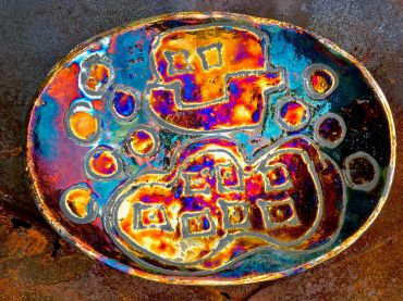Colorful abstract ceramic plate with geometric patterns.