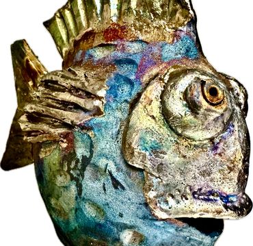 A colorful, textured fish sculpture with metallic hues.