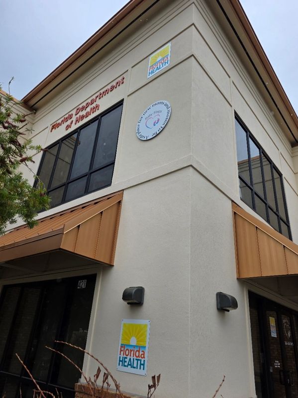 Corner view of the Florida Department of Health building with clear signage and windows.