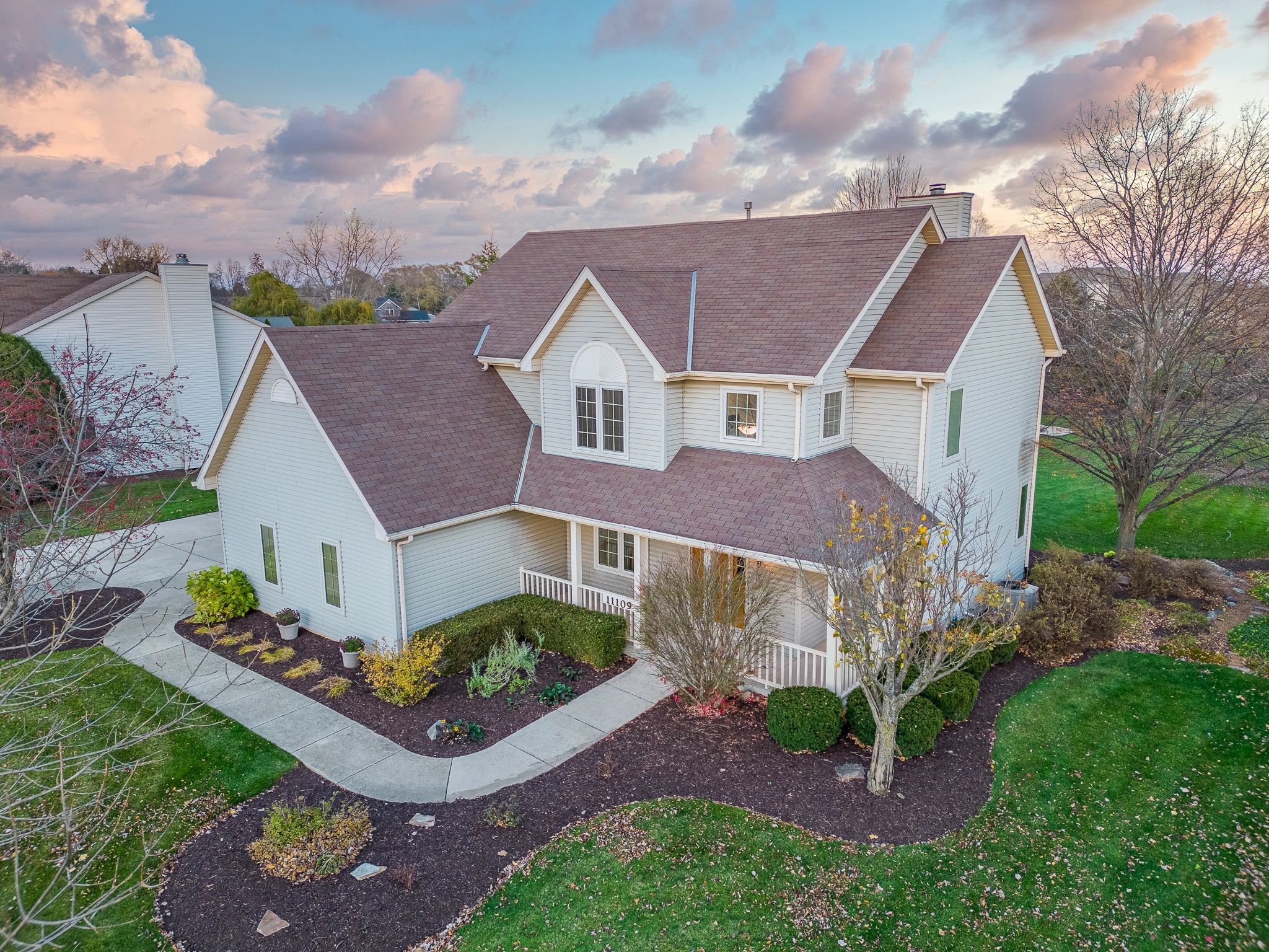 Aerial drone photograph of a residential property showcasing the home and yard for real estate listi