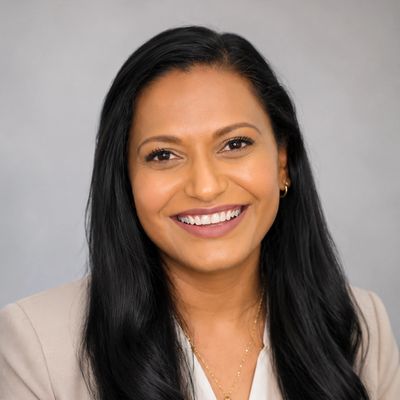 Professional woman with long black hair smiling confidently.