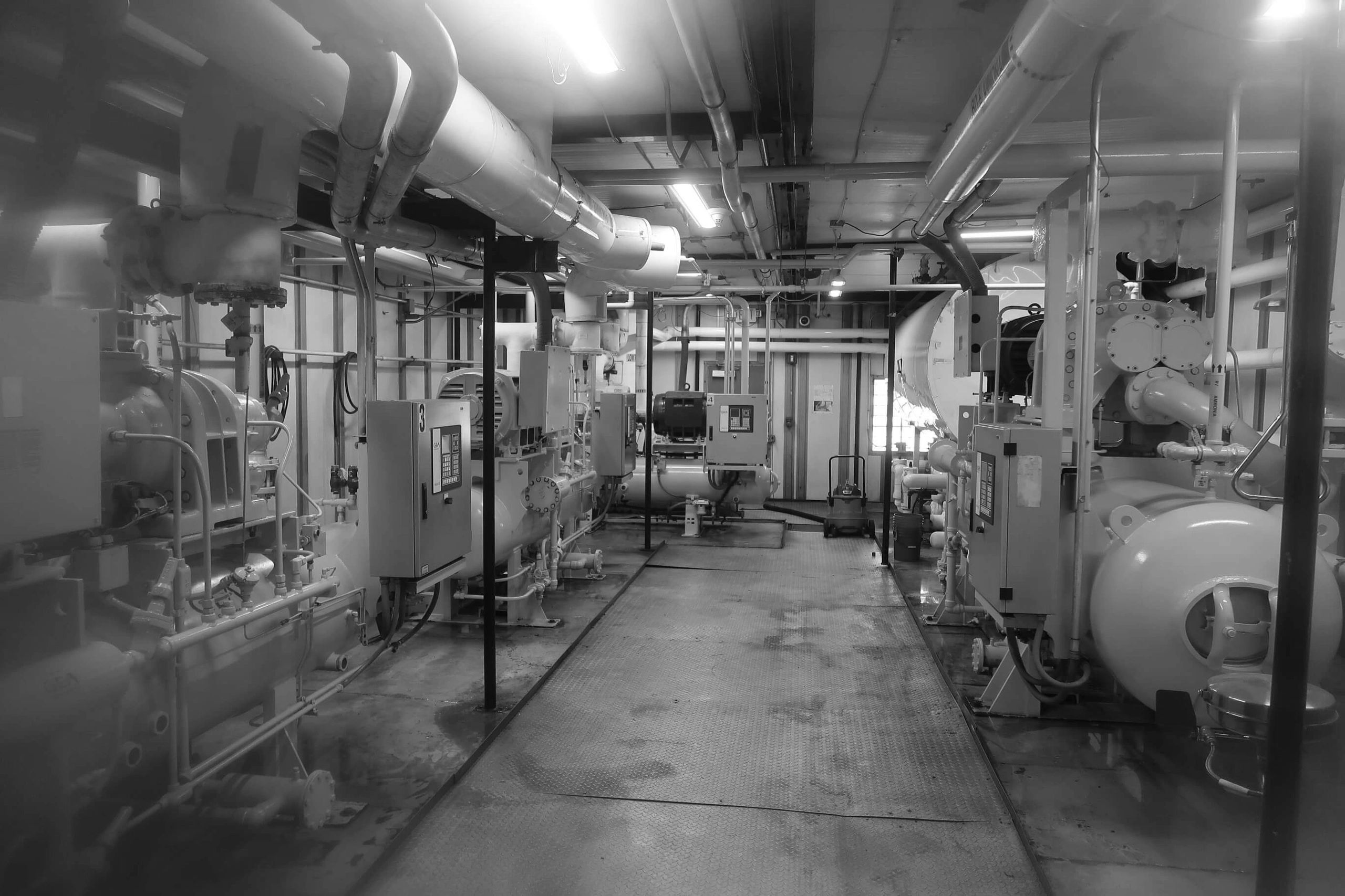 Ammonia refrigeration engine room NH3 R717 with compressors on either side of a center aisle