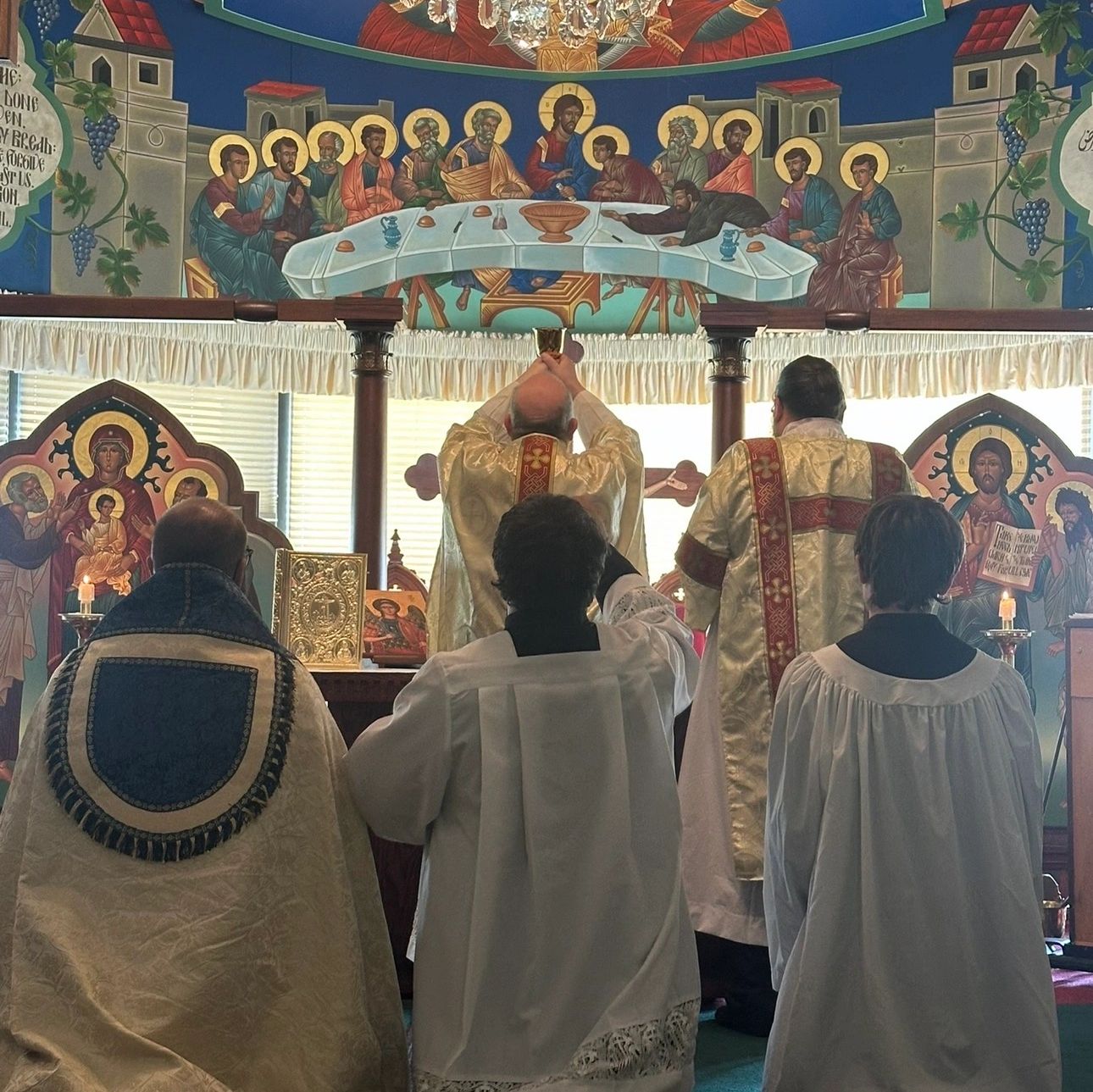 Clergy performing a religious ceremony in an ornately decorated church.