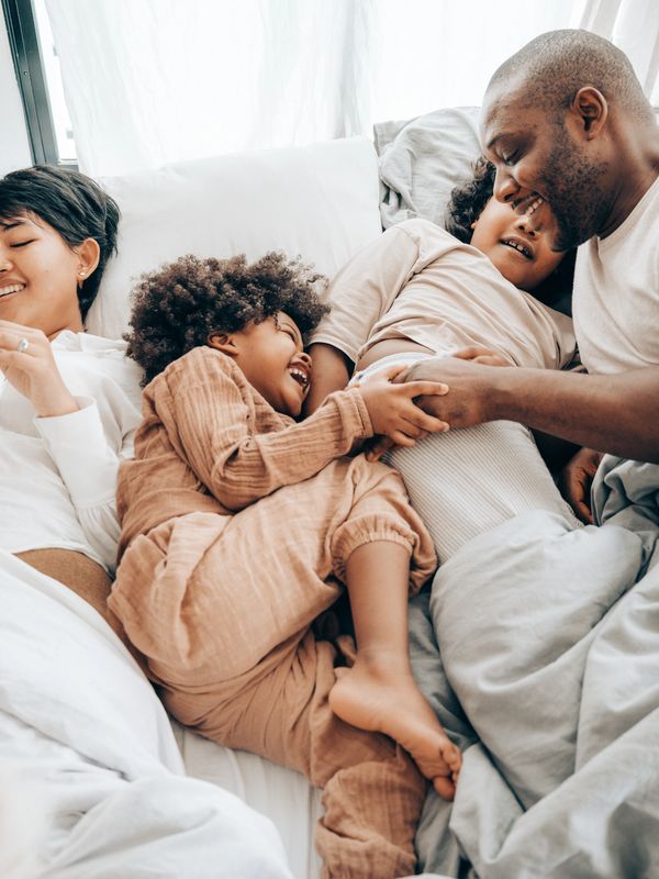Parents and their kids laughing and having a good time.